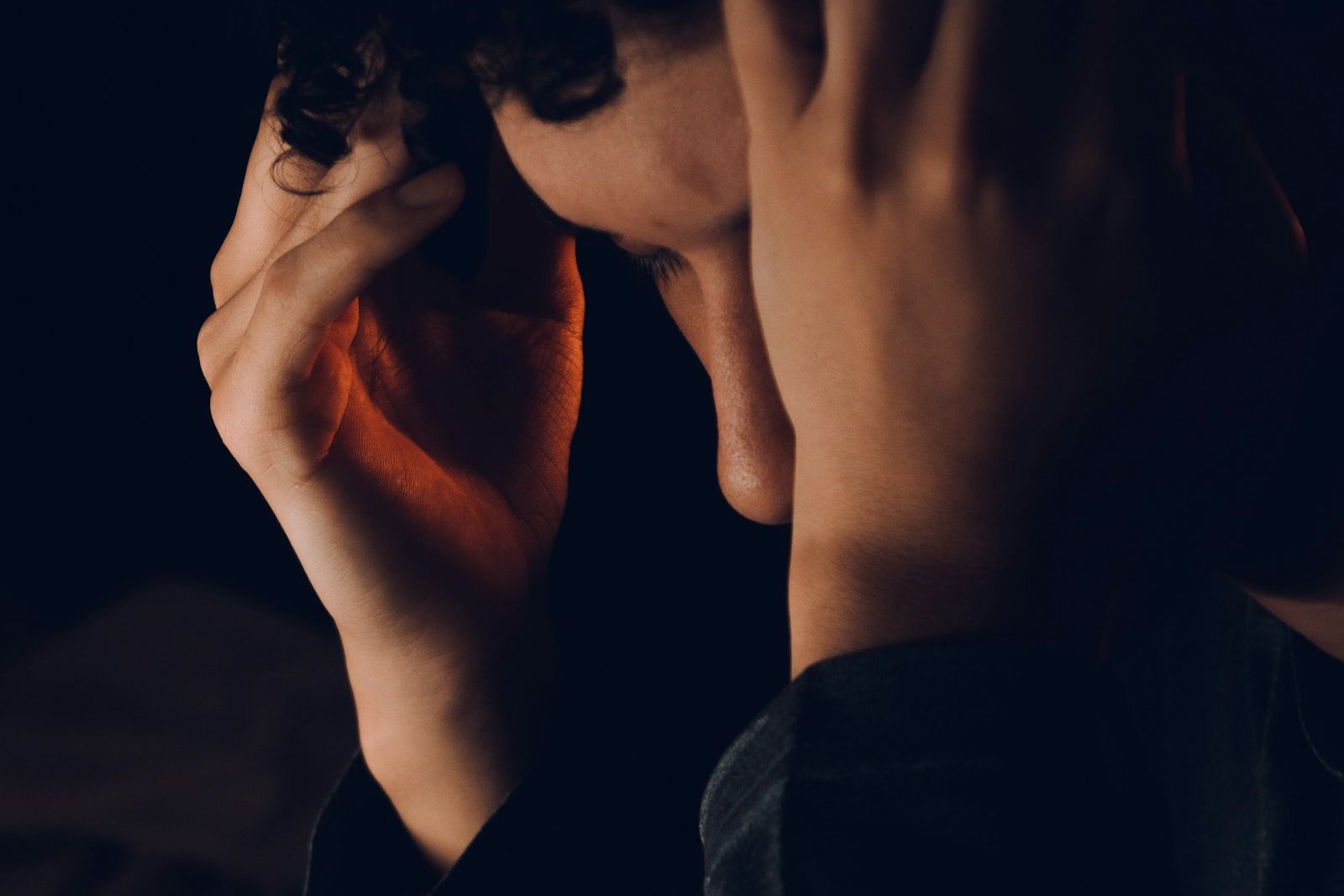 A person with their hands raised to their face, a quiet moment of uncertainty rather than dramatized distress