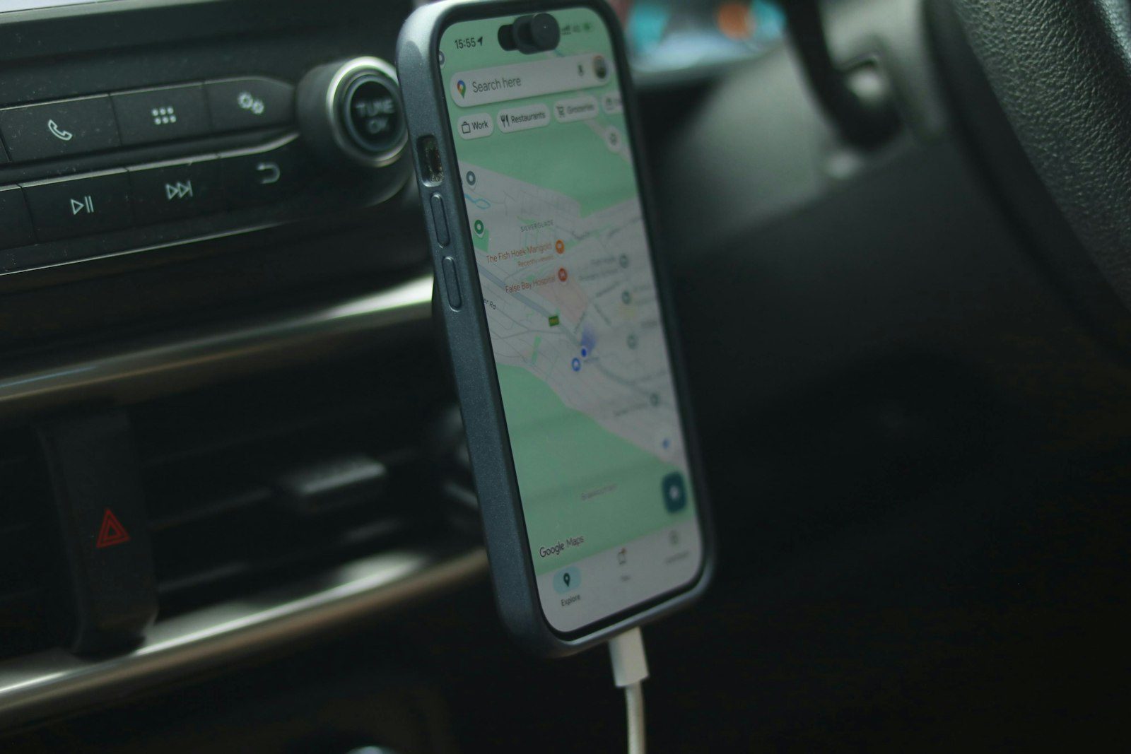 A smartphone mounted in a car showing a navigation app
