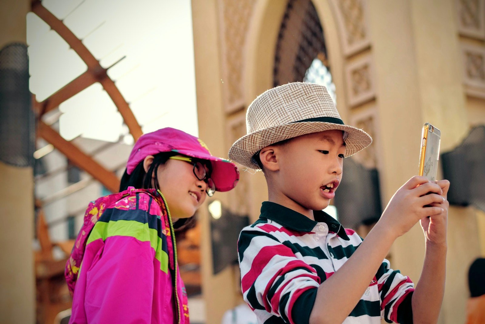 Two children looking together at a phone